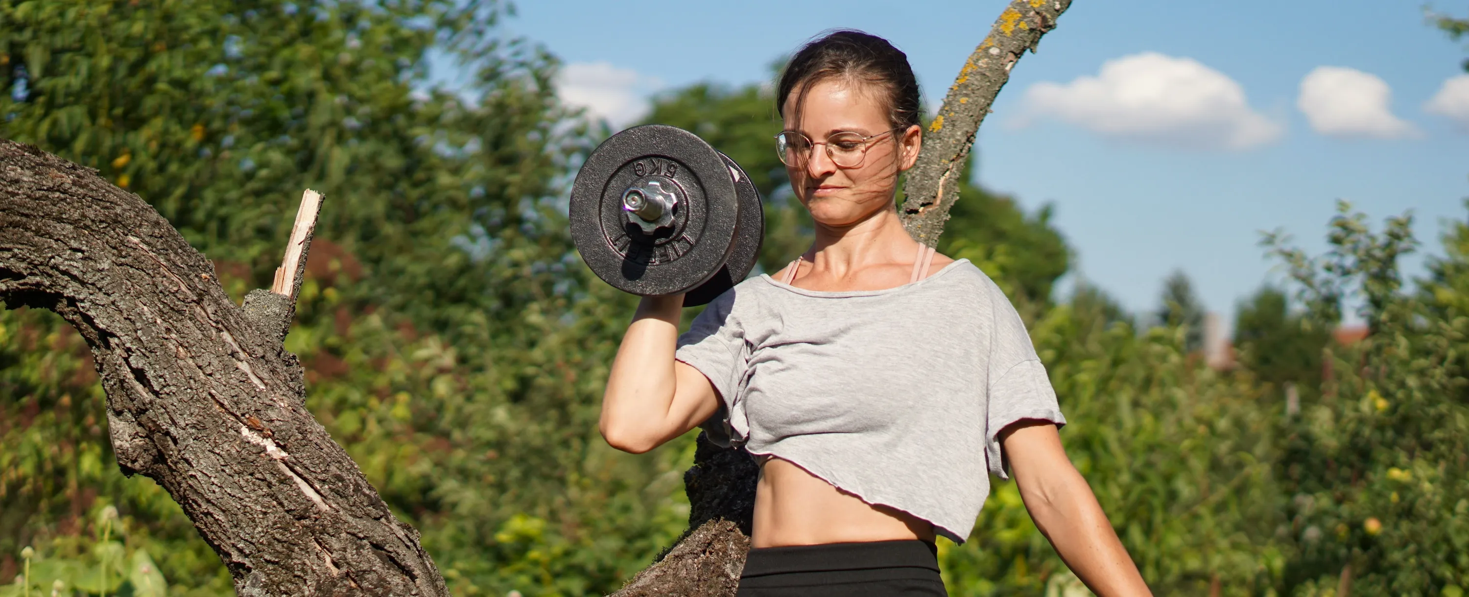 Woman trainer performing overhead press