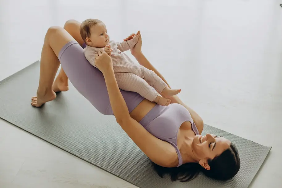 New mom exercising with a newborn baby
